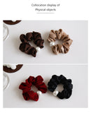 Lifestyle image: pearl hair tie holding low bun on model with natural lighting