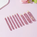 Front view of 9-piece wooden handle makeup brush set with rhinestone accents on white background