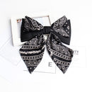 Detail of stitched bow on black cashew hair clip