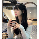 Close-up of hand-set glass crystals on soft nylon mesh fabric