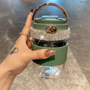 Tumbler in transit: secured in car cup holder with lid closed