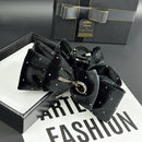 Close-up of rhinestone-accented bow detail on black velvet