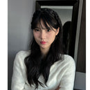 Close-up of crystal detailing on black satin headband surface