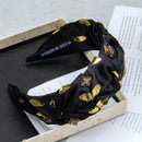 Close-up detail of hand-set rhinestones on black fabric band