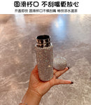 Backlit shot of pink tumbler highlighting reflective stainless steel finish