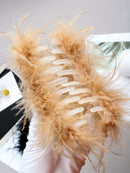 Flat lay with accessories: pearl hairpin and velvet pouch beside clip