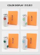 Green tumbler beside graduation cap and diploma — celebration occasion