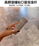 Red tumbler beside laptop and notebook on desk setup