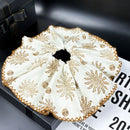 Side detail showing layered petal-like fabric and soft gathers on caramel variant