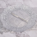 Dessert spoon resting beside a ceramic dessert plate with fresh berries