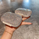 Hand holding pill box to show scale and ergonomic size