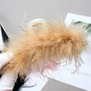 Close-up detail of hand-assembled feather texture and mink fur trim