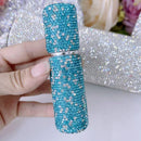 Lifestyle image of three perfume atomizers arranged on a marble bathroom counter