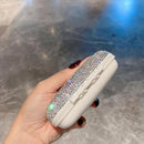 Nightstand setup with pill box, reading glasses, and alarm clock