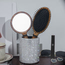 Front view of SUUMEE wooden vanity set on marble countertop — hairbrush, round mirror, and storage canister arranged together