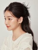 Lifestyle shot of clip placed on marble surface with dried florals