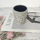 Champagne leather desk organizer next to notebook and coffee cup in lifestyle shot