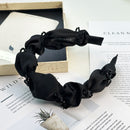 Hair band styled on model with soft side-parted waves