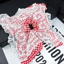 Side angle showing elasticity and layered lace construction of hair tie