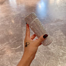 Red tumbler placed beside keys and wallet for on-the-go context