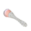 Gold-colored brush held in hand demonstrating comfortable grip and control