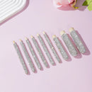 Side angle detail of wooden makeup brush handle showing rhinestone banding and grain texture