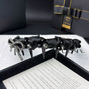 Black satin bow headband styled on model with natural hair and minimalist outfit