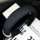 Close-up detail of genuine freshwater pearls on denim fabric