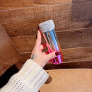 Front view of compact rainbow stainless steel tumbler on white background