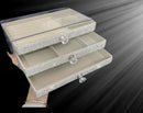 Three-drawer jewelry box shown with stacked rings, studs, and small pendants inside each compartment