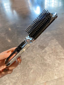 Mirror comb placed inside an open handbag showing portability