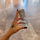 Close-up of crystal embellishments on the shoulder of a blush pink spray bottle