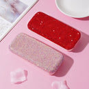 Close-up of crystal arrangement and leather grain texture on eyewear storage box