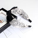 White cashew headband worn with low bun hairstyle lifestyle photo