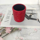 Aqua blue desk organizer holding makeup brushes on vanity setup