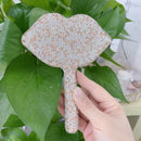 Top-down view highlighting symmetrical crystal placement on teardrop mirror